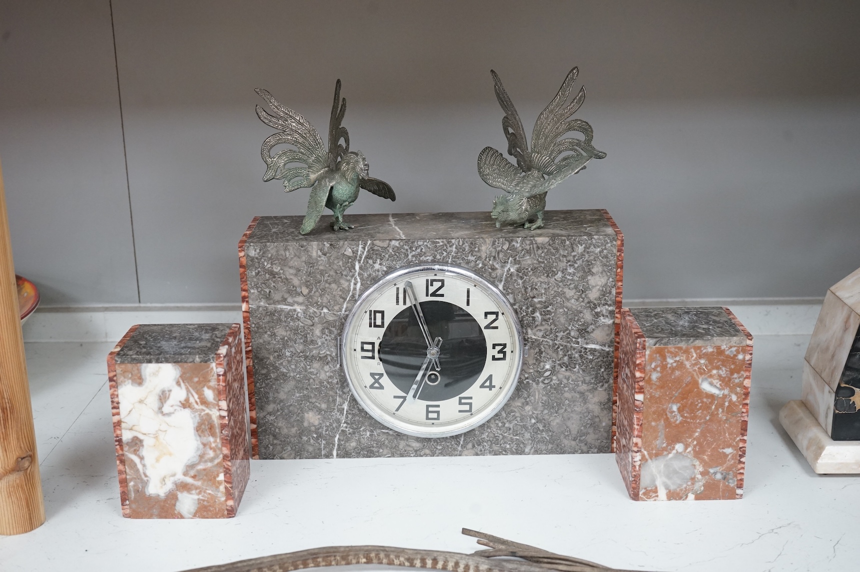 An Art Deco marble clock garniture and a French clock surmounted with two deer, with key, 44cm wide